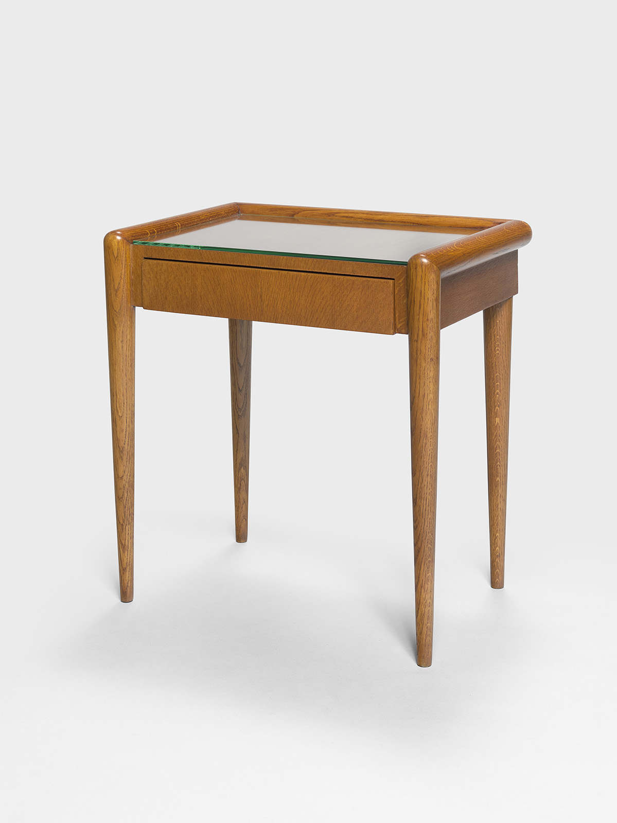 JEAN ROYÈRE - Bedside table, ca. 1950 – Oak and glass